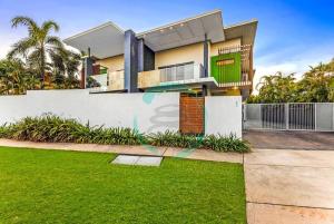 a house with a fence and a yard at ZEN ARCTIC Luxury 2-Story T/House + Pool & Markets in Fannie Bay
