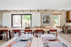 a dining room with a large table and chairs at Domaine de Panery in Pouzilhac