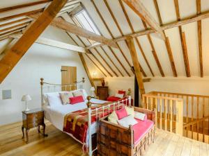 a bedroom with a bed in a attic at 16th Century Cartlodge with private hot tub in Diss