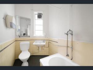 a bathroom with a white toilet and a sink at Richmond Private Rooms - 151 Hoddle Homestay in Melbourne