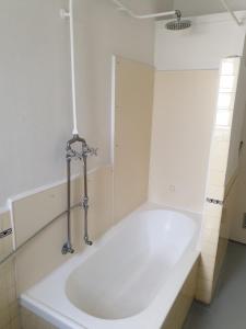 a bath tub in a bathroom with a sink at Richmond Private Rooms - 151 Hoddle Homestay in Melbourne