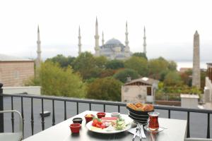 a table with two plates of food on a balcony at HaciBayramHotel in Istanbul