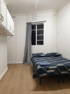 a bedroom with two beds and a window at Richmond Private Rooms - 151 Hoddle Homestay in Melbourne