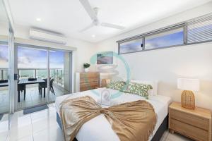 a bedroom with a bed with a bow on it at ZEN SEA BREEZE - Darwin's Premier Family Apt in Darwin