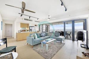 a living room with a couch and a table at ZEN PARADISE - 2-BR Waterfront Ocean View Retreat in Darwin