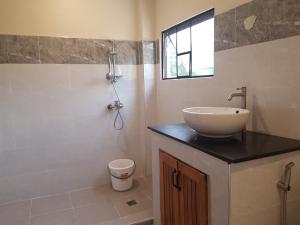a bathroom with a sink and a shower at The old normal private residences in Panglao
