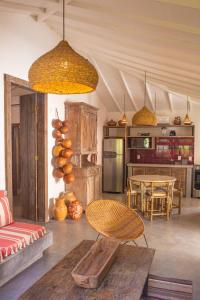 a living room with a table and a kitchen at Hotel Boutique Perainda in Trancoso