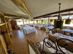 a dining room with white tables and chairs at Eifel Hotel Haus West in Kall