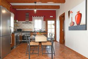 a kitchen with a table and chairs in a room at Villa Mica in Tijarafe