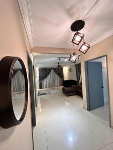 a room with a mirror and a living room at Naura Homestay Selangor Kuala Lumpur in Batu Caves +1 photo