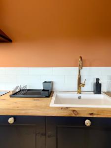 a kitchen with a sink and a counter with aounter at Chopin view - Apartament z widokiem in Toruń