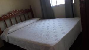 a bed in a bedroom with a white mattress at Afecto in San Gregorio de Polanco