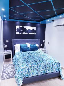 een slaapkamer met een groot bed met blauwe lakens en blauwe plafonds bij M/H house (#1) cozy and beautiful house near the airport and the beach in Carolina