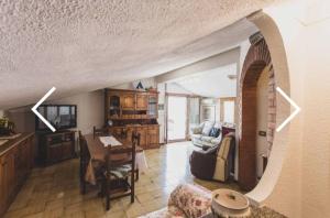a living room with a table and a couch at Panoramico a Monte Argentario in Porto Santo Stefano