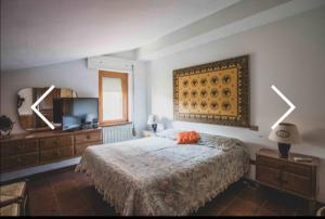 a bedroom with a bed and a flat screen tv at Panoramico a Monte Argentario in Porto Santo Stefano