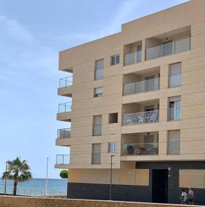 ein Gebäude am Strand neben dem Meer in der Unterkunft Precioso apartamento primera línea de playa in Águilas