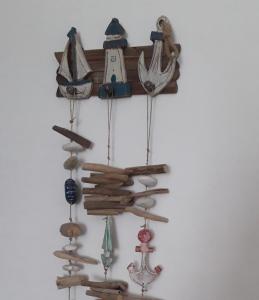 a group of wooden items hanging on a wall at Casa in SALENTO a Otranto in Otranto