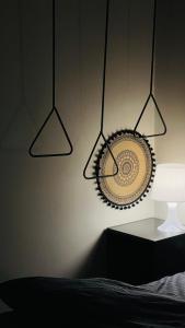 a bedroom with two lights and a plate on the wall at شقة خاصة بتصميم مختلفة وجميل في موقع ممتازEntire apartment in Al Ahsa