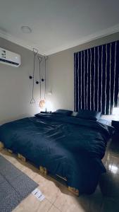 sypialnia z dużym niebieskim łóżkiem z 2 lampami w obiekcie Entire apartment w mieście Al Ahsa