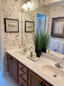 a bathroom with two sinks and a large mirror at Suite Melissa's Pinehurst Country Club #6 Private Room and Bath in Pinehurst