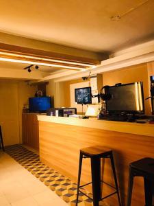 a bar with a flat screen tv on top of it at CHE & JAMES FEMALE GUEST House COLON, CEBU in Cebu City