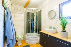 a bathroom with a shower and a toilet and a sink at Domek letniskowy nad jeziorem in Łąck +24 photos