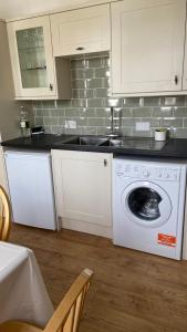a kitchen with a washing machine in a kitchen at Bexhill Luxury Sea Stay Flat 2 in Bexhill