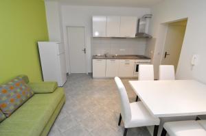 salon z kanapą i stołem oraz kuchnia w obiekcie Apartments Marija - Maslenica w mieście Maslenica