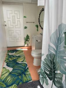 a bathroom with a toilet and a shower curtain at Habitacion Centrica Calle 8 Miami (2) in Miami