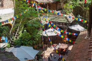 an overhead view of a yard with flags and umbrellas at New Orleans Apartment in Kathmandu