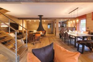 a dining room and living room with a table and chairs at Chalet le Bonheur in Méribel