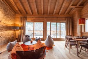 a living room with a table and chairs at Chalet le Bonheur in Méribel