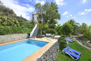 a villa with a swimming pool and a resort at Villa El Buen Jes&uacute;s in Tijarafe