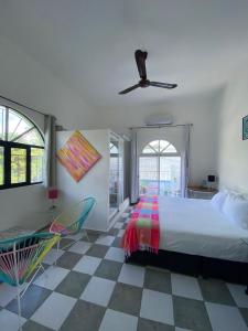 a bedroom with a bed and a ceiling fan at The Quetzal in Cancún
