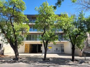 an office building with trees in front of it at Mendoza Chill in Mendoza