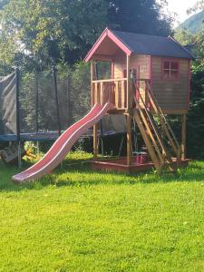 a playground with a slide in the grass at Ertlhof Rottau in Rottau