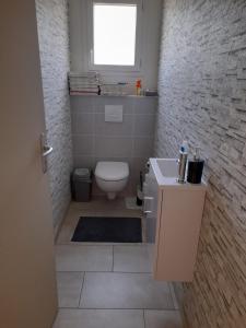 a bathroom with a white toilet and a window at CHEZ VIVIANE in Celles-sur-Belle