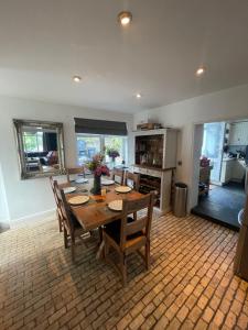 a dining room with a wooden table and chairs at Lauderdale lodge barnstaple in Barnstaple