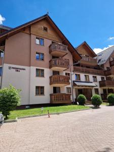 a large apartment building with a brick courtyard at Hej to tu apartamenty Karpacz in Karpacz