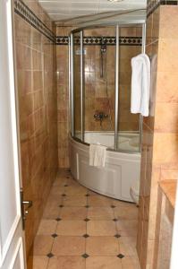 a bathroom with a shower and a tub and a toilet at Hotel By Karaaslan Inn in Kuşadası