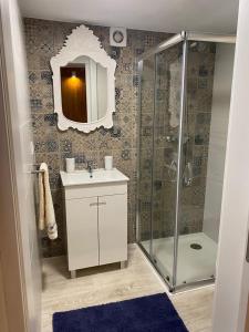 a bathroom with a shower and a sink and a mirror at Casa da Pena in Mondim de Basto