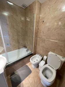 a bathroom with a toilet and a shower and a sink at Depto moderno y luminoso La Plata zona céntrica in La Plata +10 photos