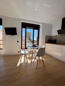 cocina y comedor con mesa y sillas en Duplex Los Serrano en Salamanca