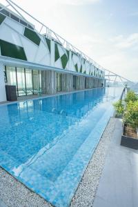 a swimming pool on the roof of a building at Lime Resort Manila in Manila