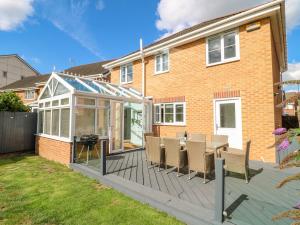 a deck with a conservatory on a house at Spire Haven in Chesterfield