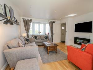 a living room with a couch and a tv at Spire Haven in Chesterfield