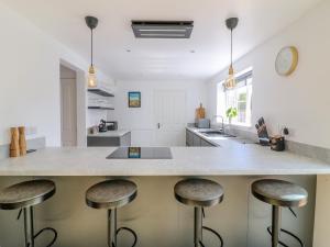 a kitchen with a large counter with stools at Spire Haven in Chesterfield