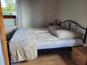 a bed sitting in a bedroom with a window at Ruheidylle Weitblick in Kleinich
