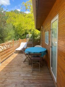 a wooden deck with a table and chairs on it at Chalet de Provence in Aix-en-Provence