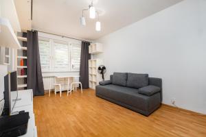 a living room with a couch and a table at Anielewicza 49 by Homeprime in Warsaw